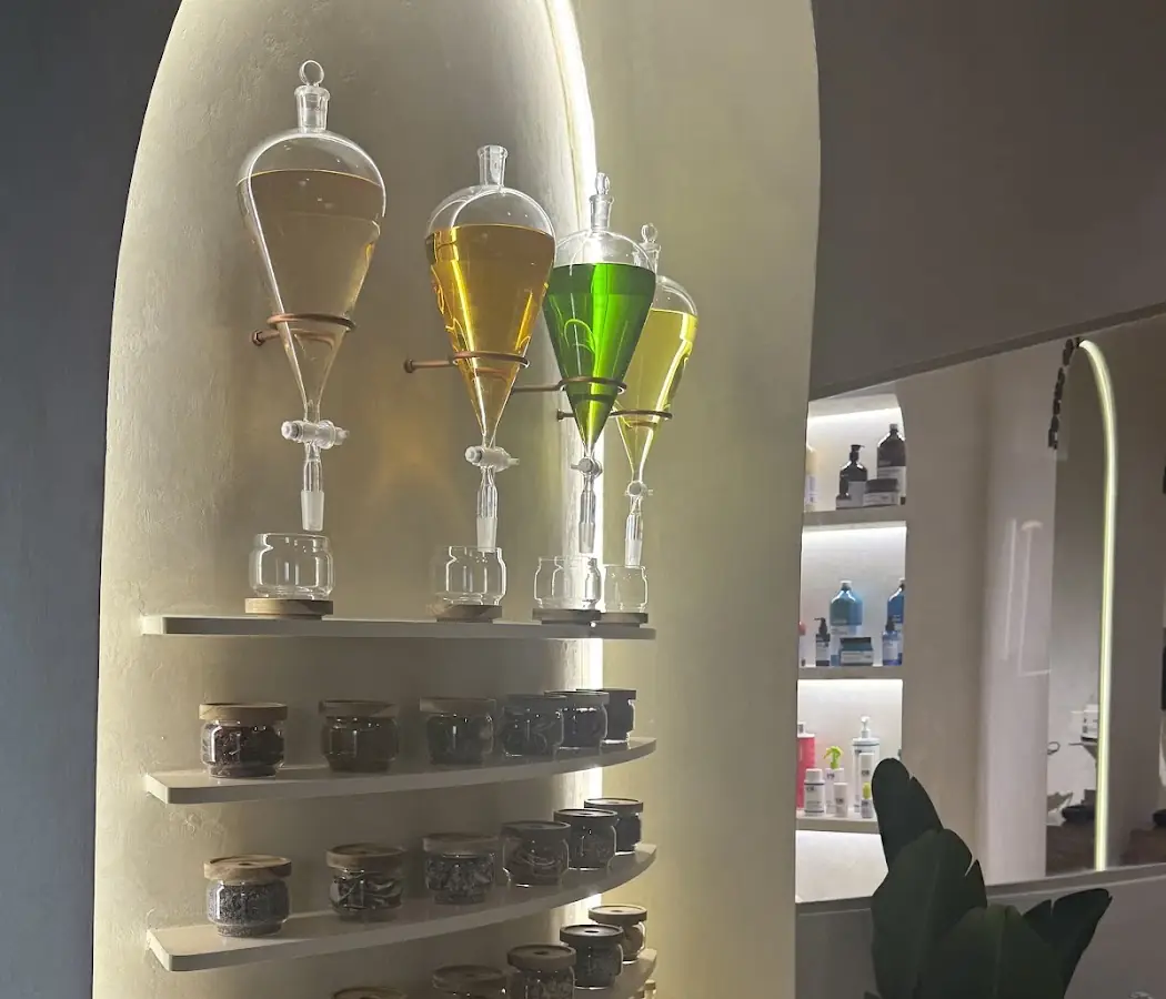 Close-up of glass flasks of oils on AVA's shelf